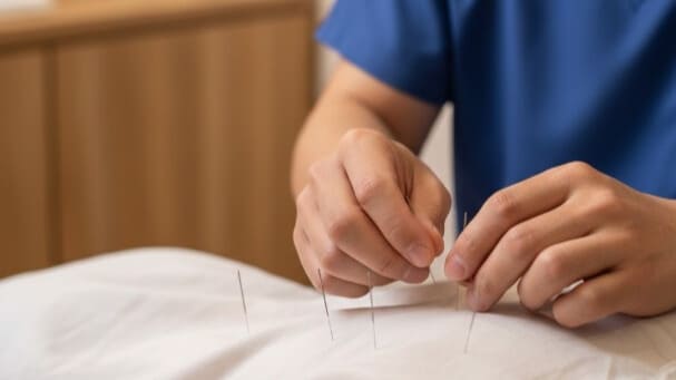 鍼灸治療を受けている患者の様子、専門家による自律神経調整の施術風景、温かく落ち着いた治療室